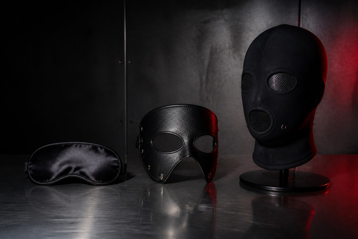 Three black BDSM masks displayed on steel with clear eye and airflow openings