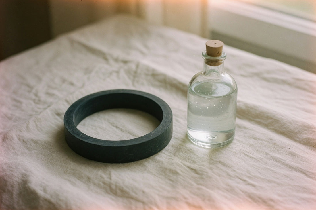 Matte black soft cock ring resting on dark fabric — simple gear for how to wear a cock ring safely