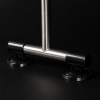 FRAME 01's T-shaped stainless-steel base with two black suction-cup feet gripping a flat surface