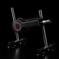 FRAME 01 thrusting sex machine — black aluminum body on splayed stainless-steel legs with four suction-cup feet