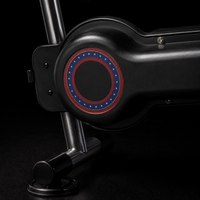 Detail of FRAME 01's red-and-blue accent ring on the black housing above a stainless leg and suction foot