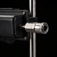 Close-up of FRAME 01's stainless-steel push-fit quick-connector attachment mount on the black housing